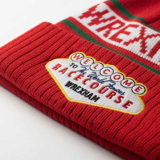 Red knit beanie with 'Wrexham' and 'Welcome to the World Famous Racecourse' text on a white background